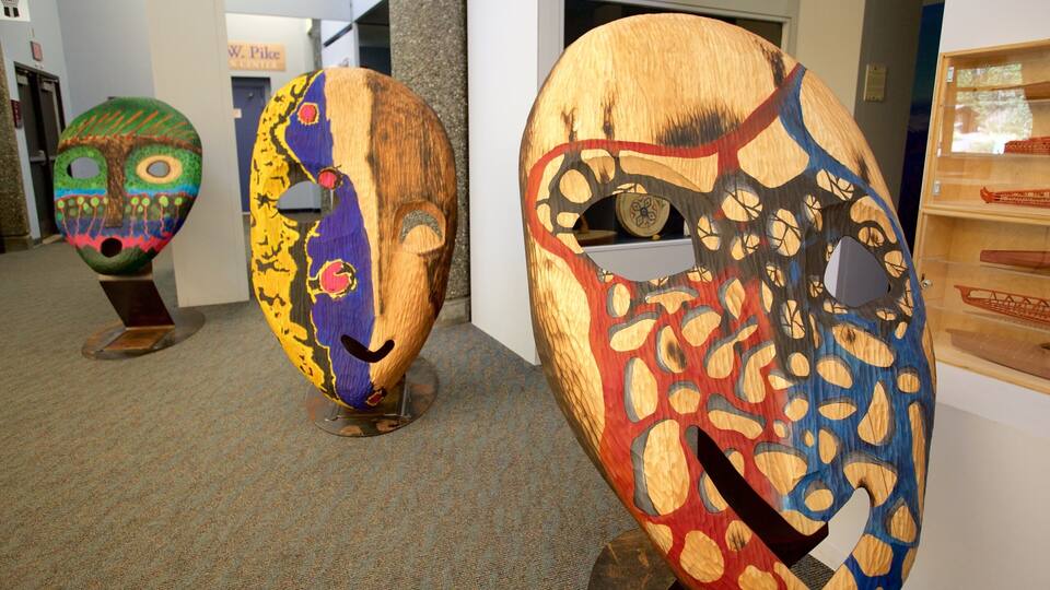 Three large wooden sculptures with colorful patterns and faces.