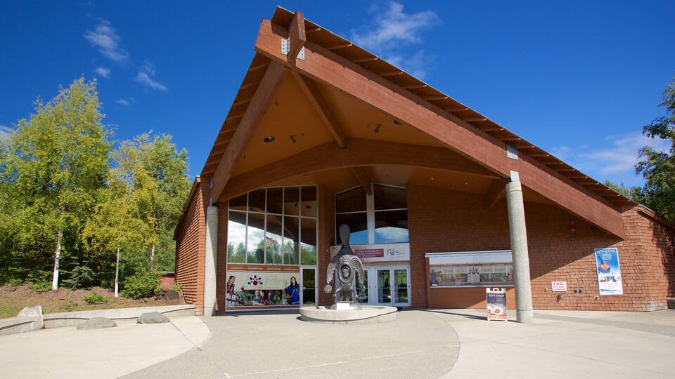 A building with a triangular roof and large windows.