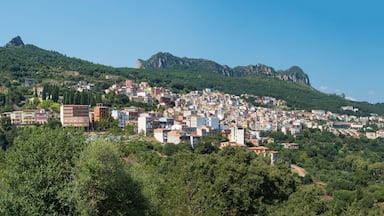 Un pueblo enclavado en una ladera, con edificios y acantilados rocosos.