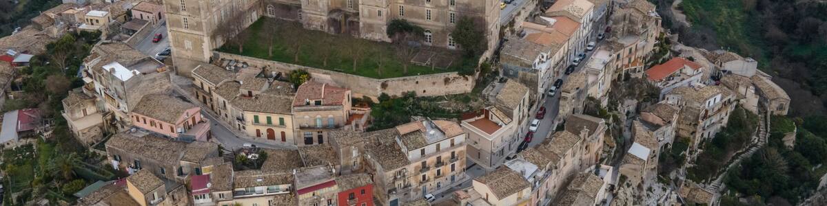 Aerial view of Dottor Solarino Palace in Ragusa Ibla, a medieval town on the hillside at sunset in Sicily, Italy.
