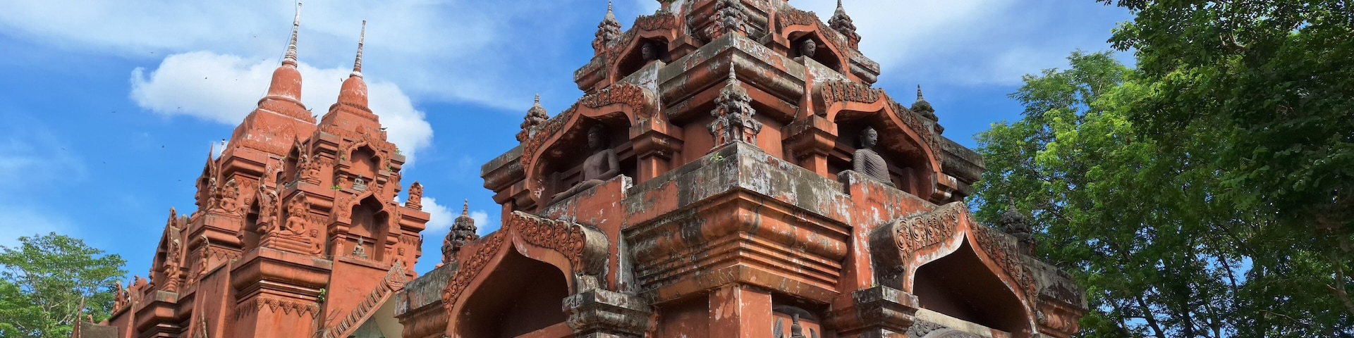 Wat Khao Angkhan 7 May 2025 The architecture of Wat Khao Angkhan with blue sky with clouds is located in Chaloem Phra Kiat District, Buriram Province, Thailand.