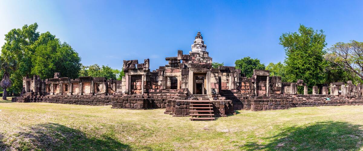 An ancient temple complex with stone structures and a central tower.