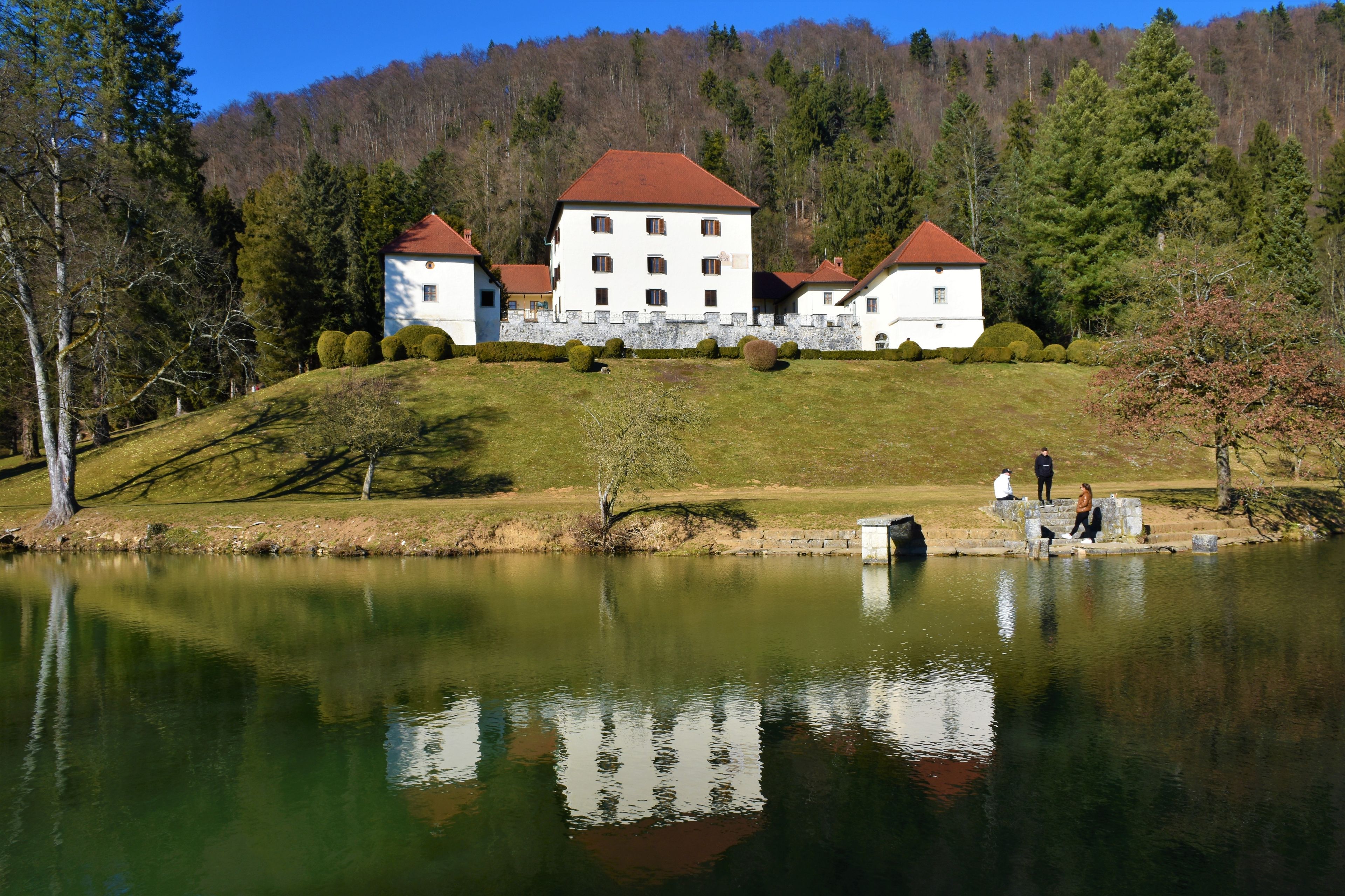 View of Strmol castle near Cerklje na Gorenjskem in Slovenia and a reflection of the catle in the lake in front