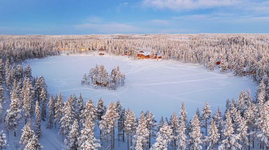 Aerial view of a tourist winter resort in the snow covered forest and the frozen lake in Kangos, Pajala, Norrbotten, Norrland, Lapland, Sweden
