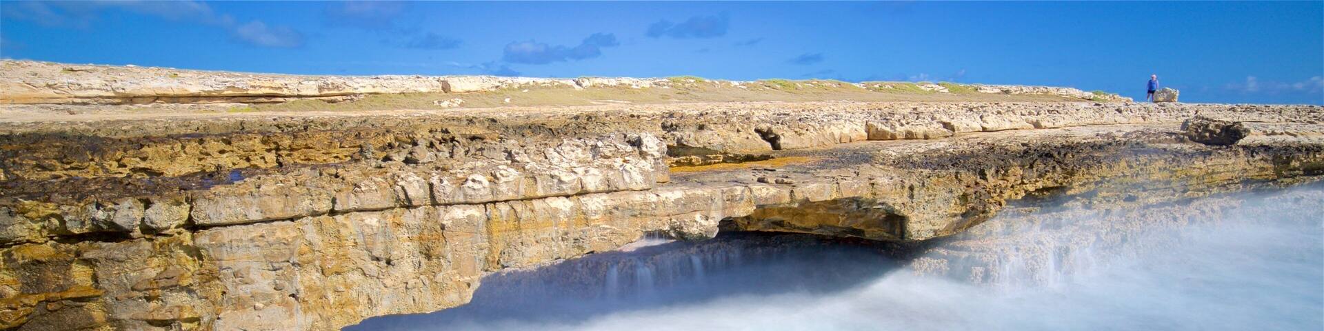 Devil\'s Bridge showing surf, rocky coastline and general coastal views