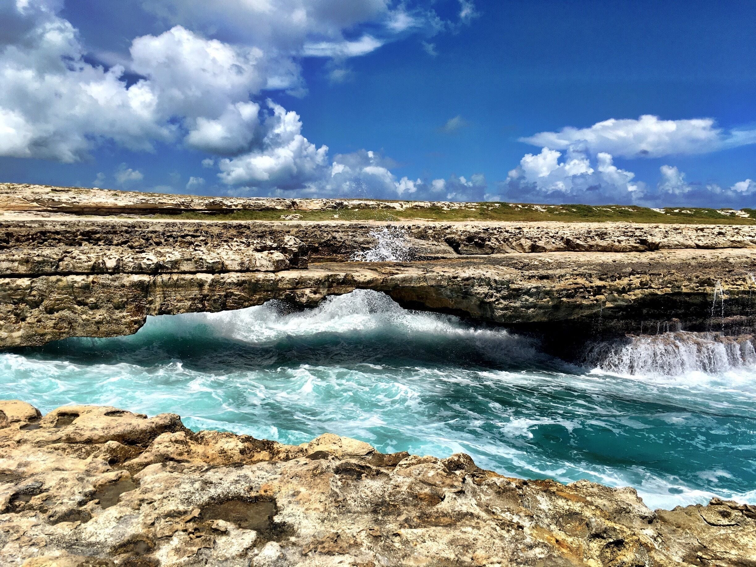 A natural bridge out of rocks across the Caribbean Sea. Beautiful! But attention! You might get wet...