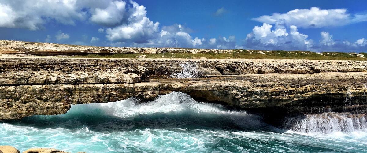 A natural bridge out of rocks across the Caribbean Sea. Beautiful! But attention! You might get wet...