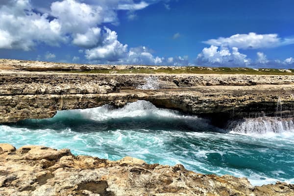 A natural bridge out of rocks across the Caribbean Sea. Beautiful! But attention! You might get wet...