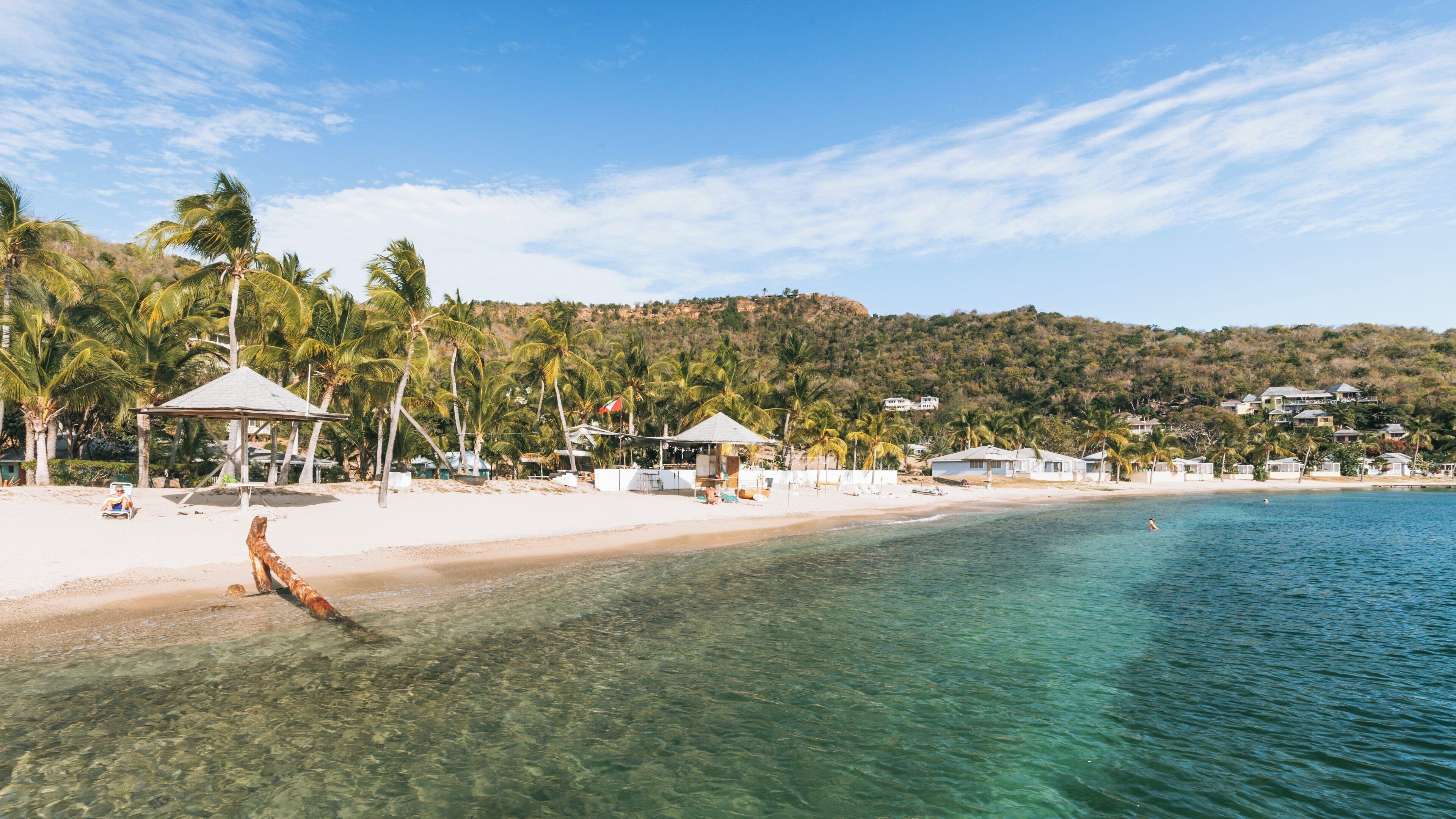 Enjoying sunny days at Galleon Beach in English Harbour Antigua and Barbuda with clear waters and palm trees swaying in the breeze