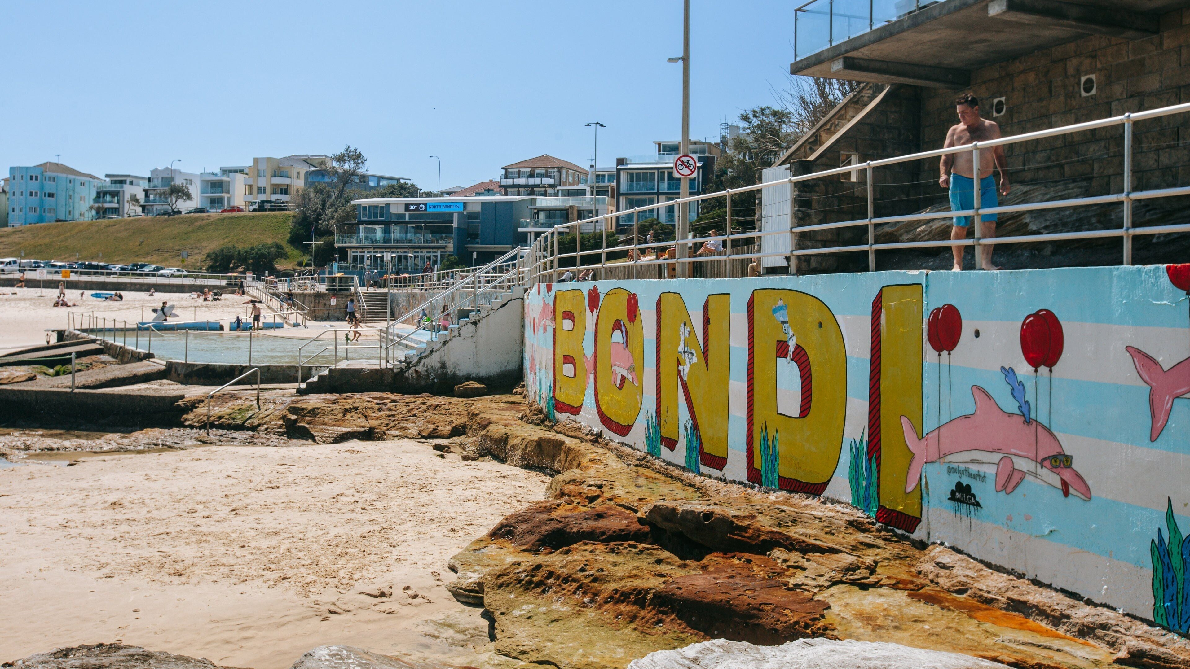 Bondi Beach which includes signage, a sandy beach and outdoor art