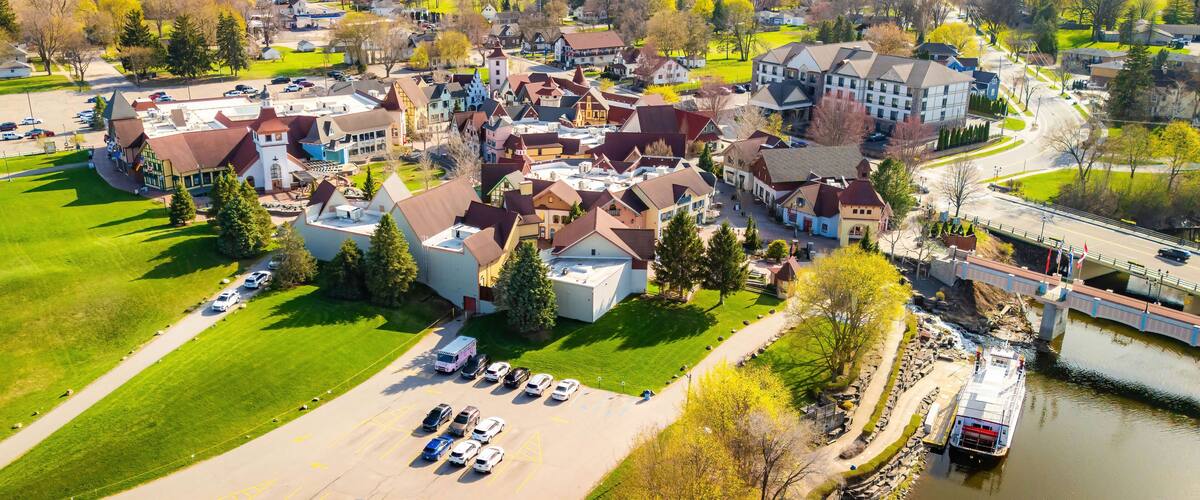 A town with historic buildings, a river, and a bridge.