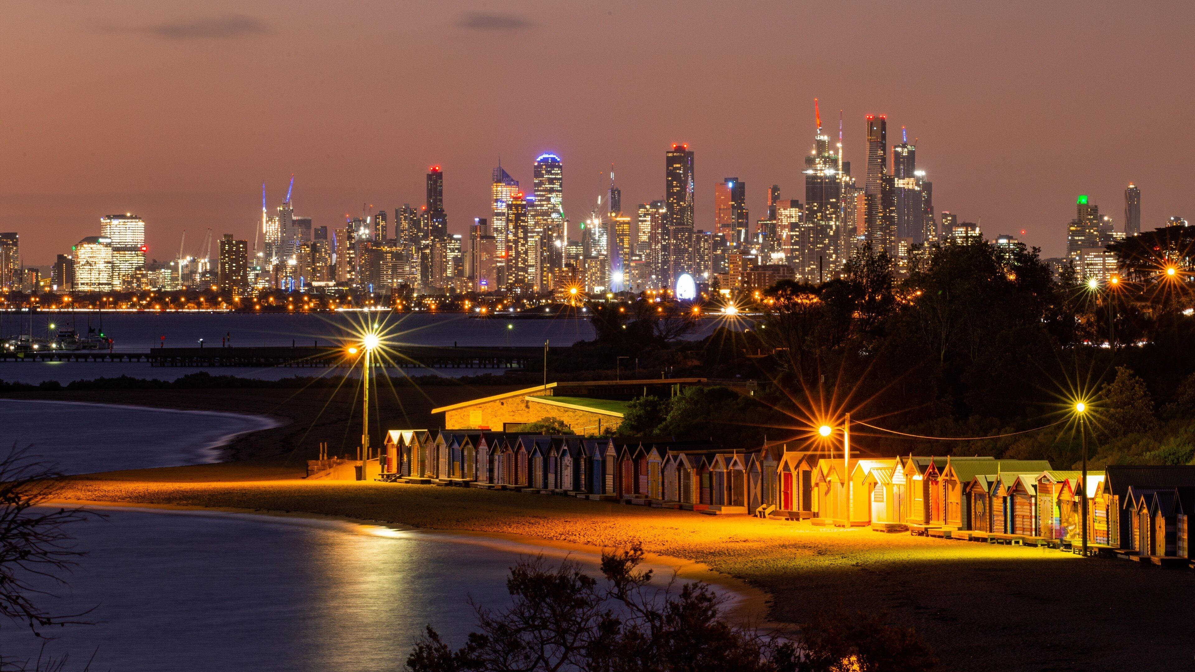 Brighton Beach featuring night scenes, a city and a sandy beach