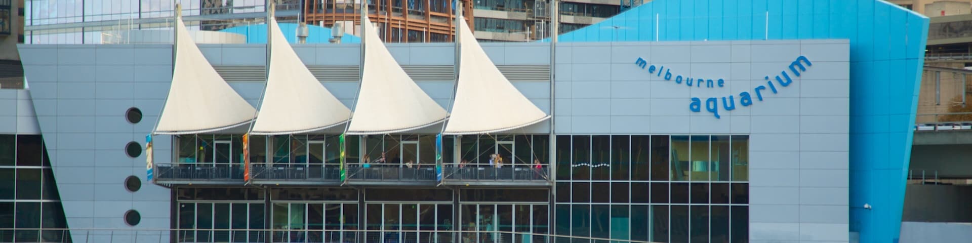 Melbourne Aquarium featuring a river or creek, signage and modern architecture