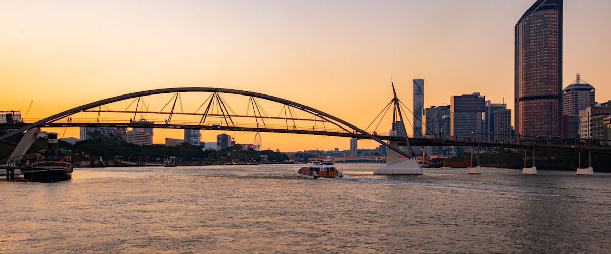 Goodwill Bridge which includes a sunset, a river or creek and a city
