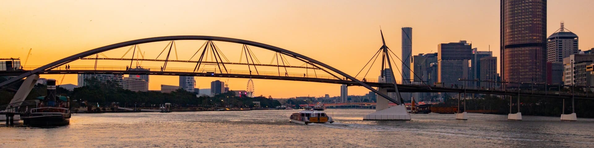 Goodwill Bridge which includes a sunset, a river or creek and a city
