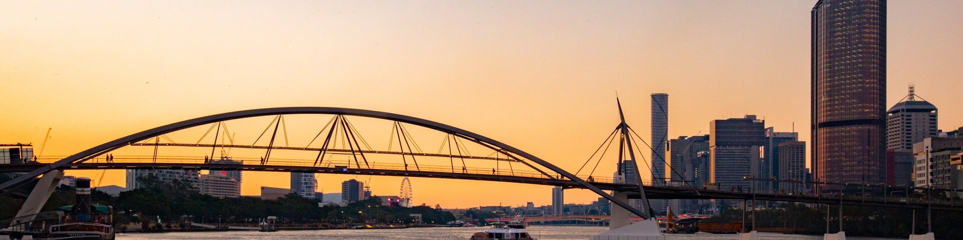 Goodwill Bridge which includes a sunset, a river or creek and a city