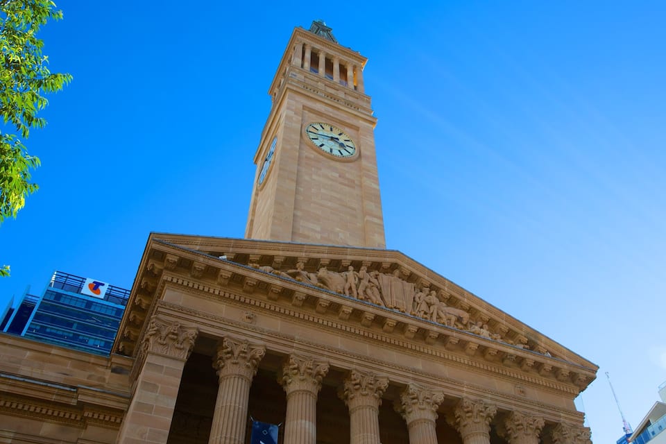 A historic building with a clock tower and classical columns.