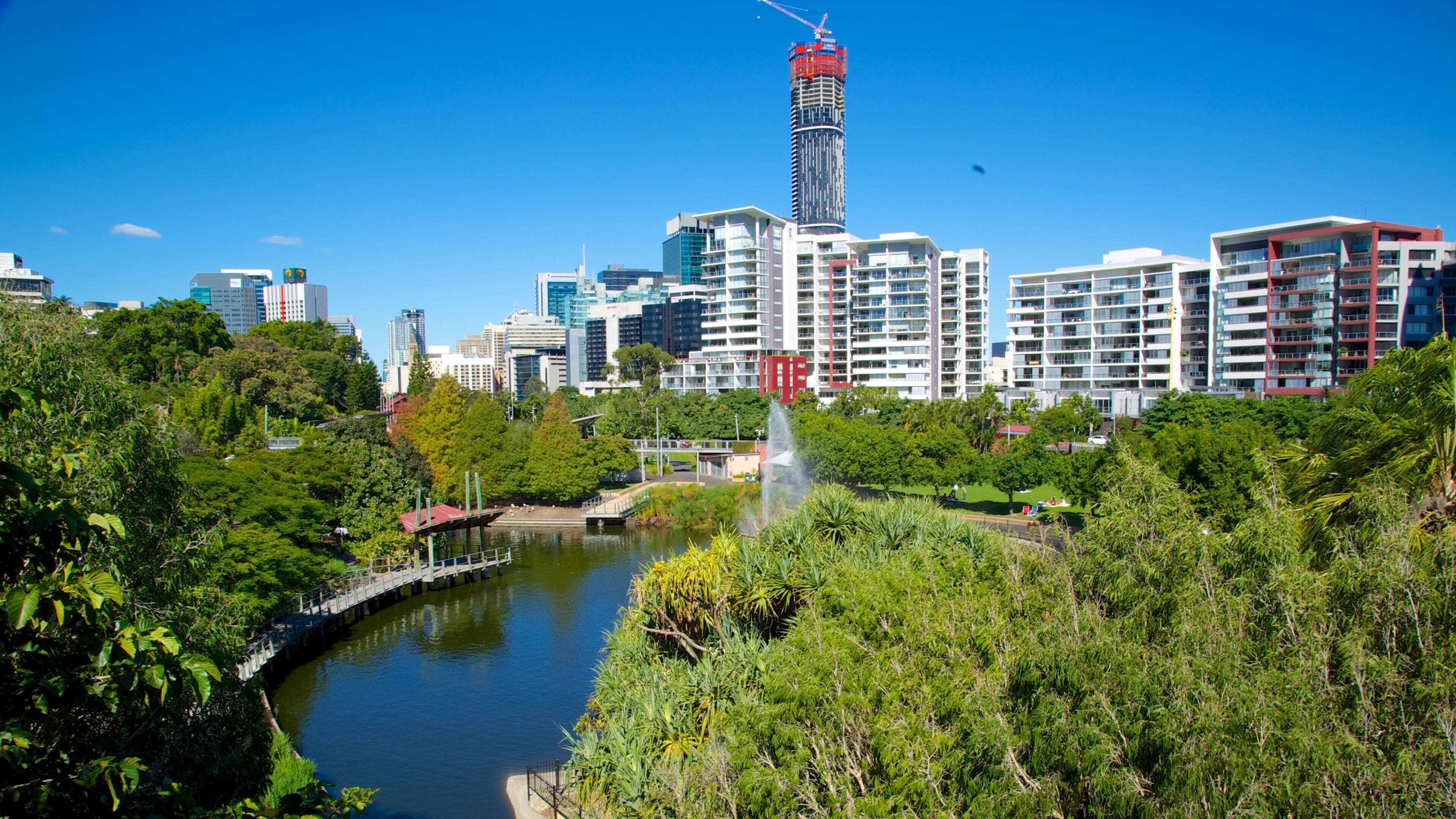 Roma Street Parkland which includes a high rise building, a city and a river or creek