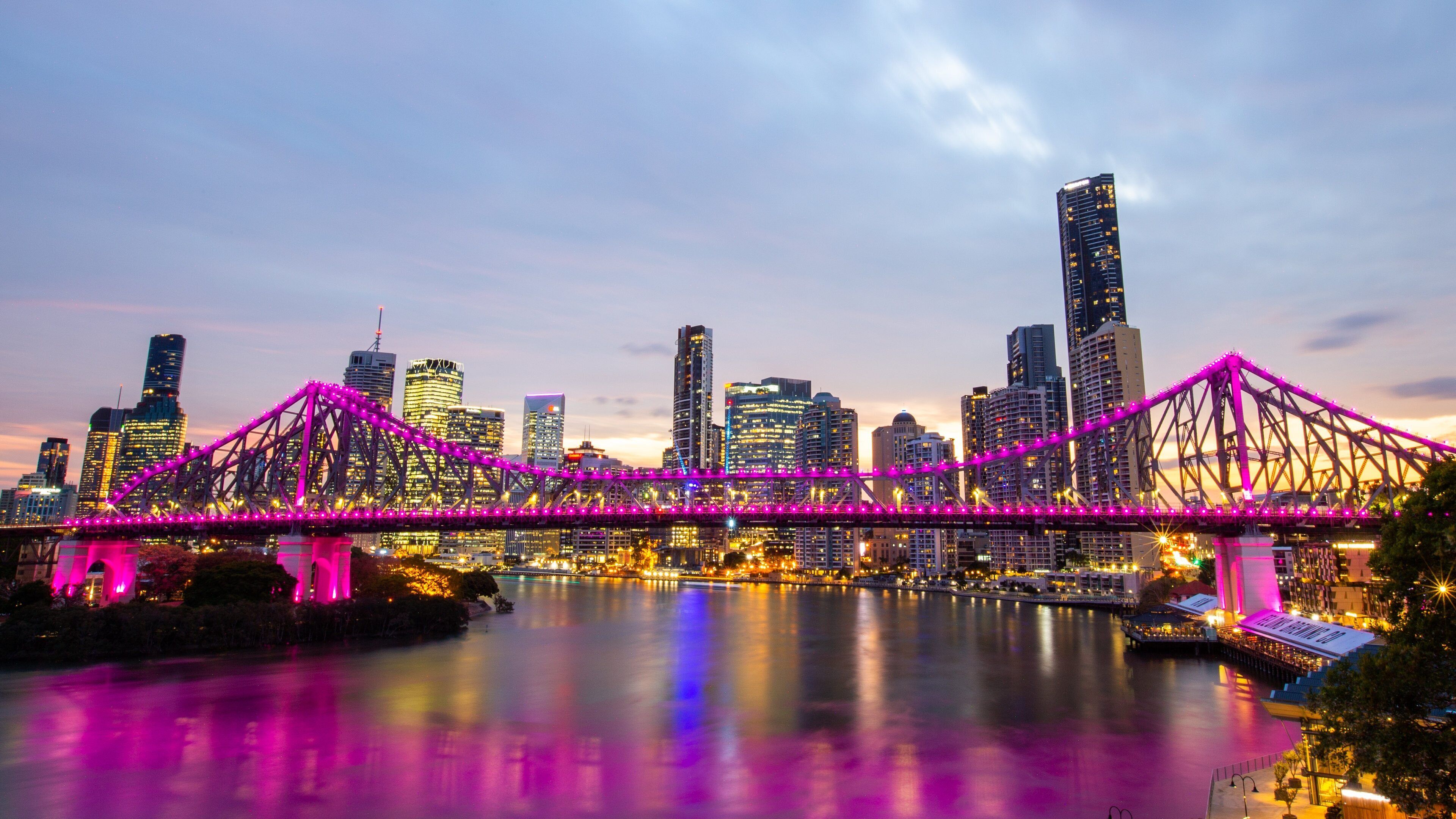 Story Bridge showing a sunset, a city and a river or creek