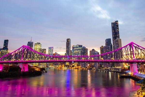 Story Bridge showing a sunset, a city and a river or creek