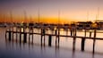 Hillarys Boat Harbour showing a coastal town, a sunset and skyline