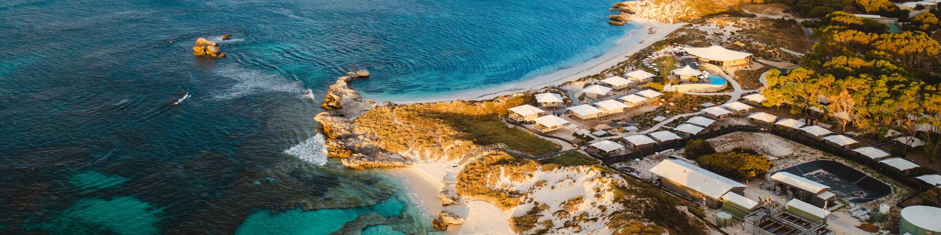 Aerial drone shot of Rottnest Island at sunrise. The Basin and Pinky beach can be seen below.
