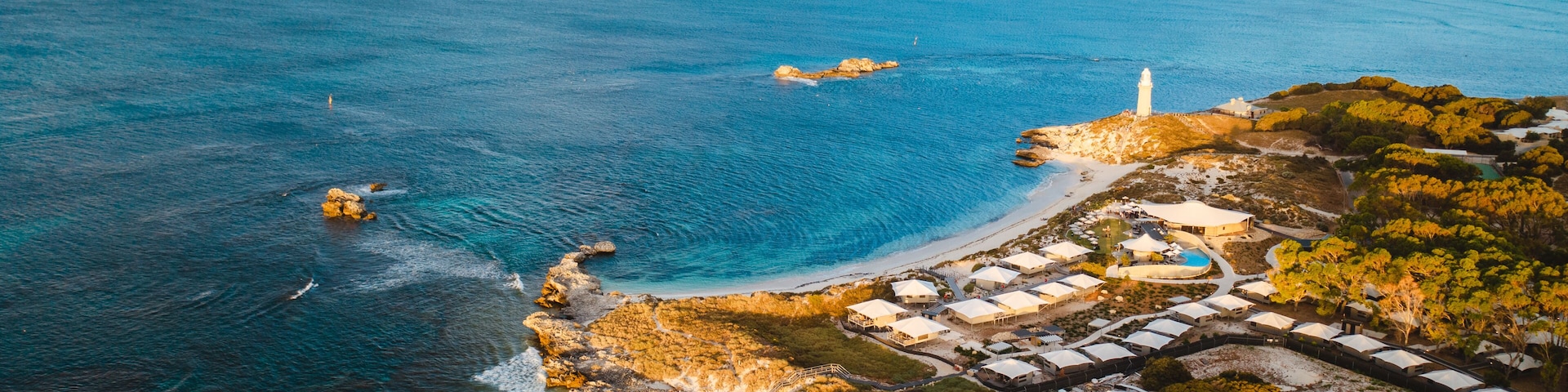 Aerial drone shot of Rottnest Island at sunrise. The Basin and Pinky beach can be seen below.