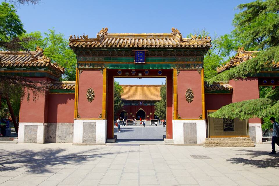 A traditional Chinese gate with intricate designs and a red and gold color scheme.