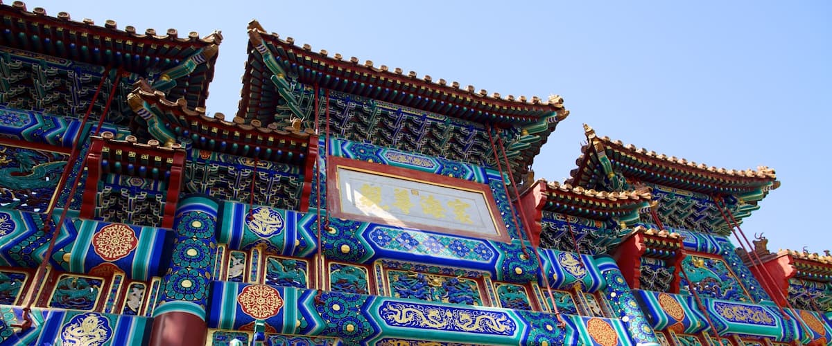 Yonghe Temple featuring outdoor art, signage and a temple or place of worship
