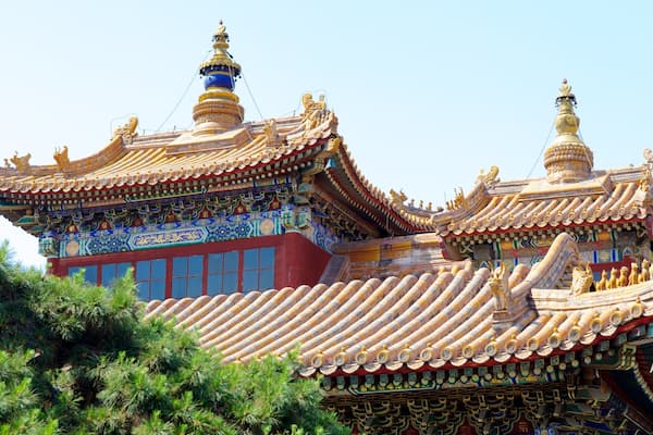 A traditional Tibetan-style building with ornate golden roofs and colorful decorations.