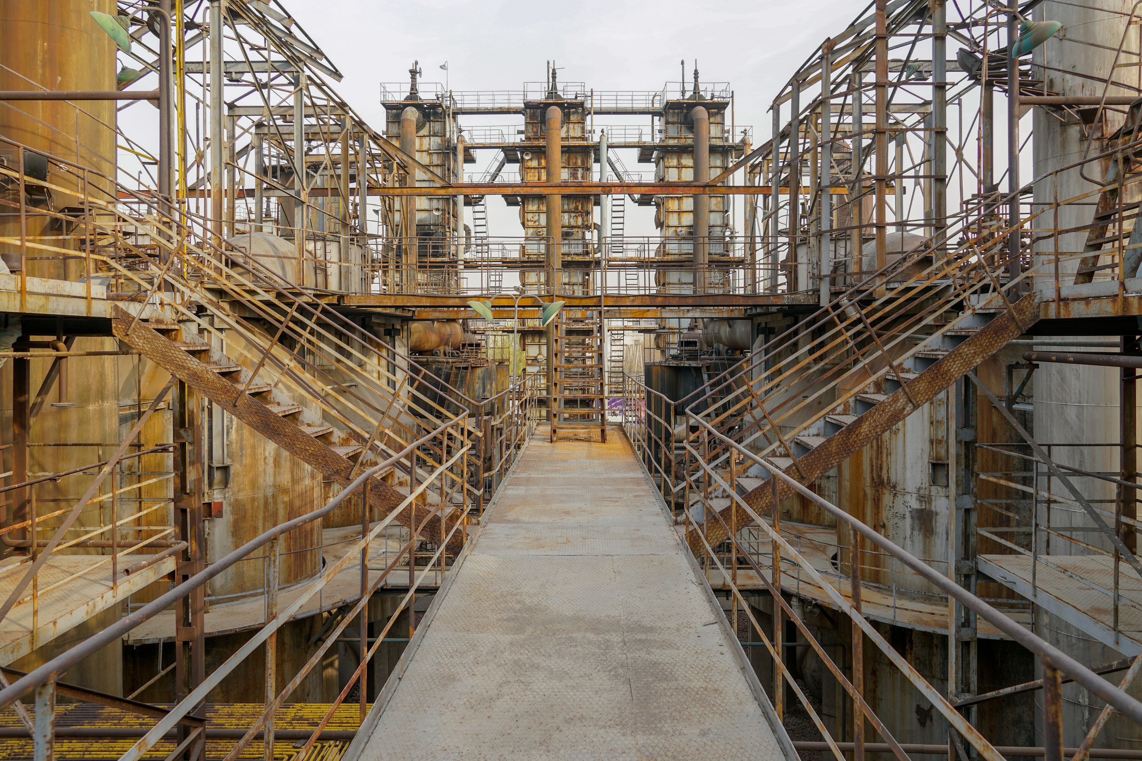 Old Factory metal structures. Industrial plant with old, rusty pipes and cooling tower for cooling water supply. Beijing, China.