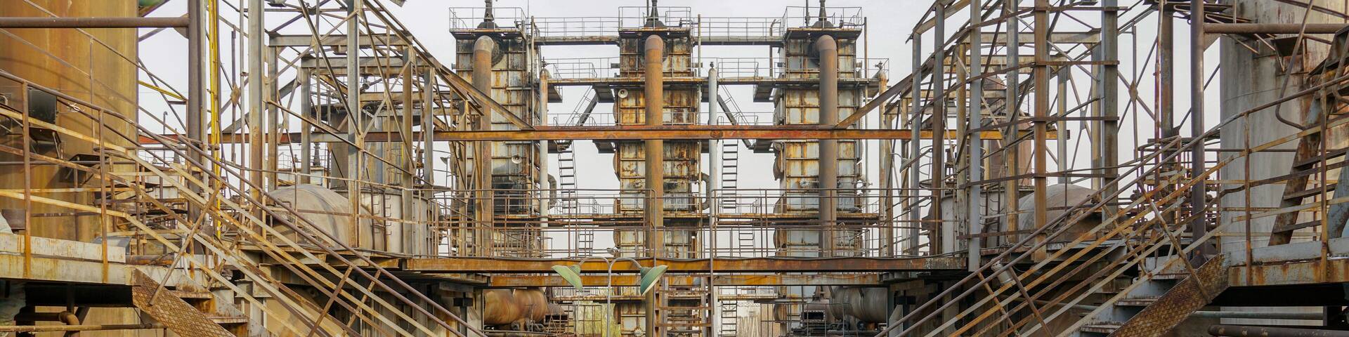 Old Factory metal structures. Industrial plant with old, rusty pipes and cooling tower for cooling water supply. Beijing, China.