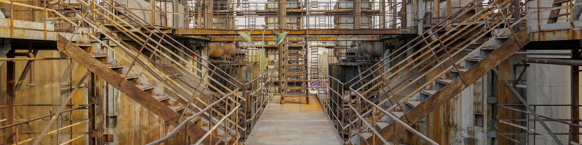 Old Factory metal structures. Industrial plant with old, rusty pipes and cooling tower for cooling water supply. Beijing, China.