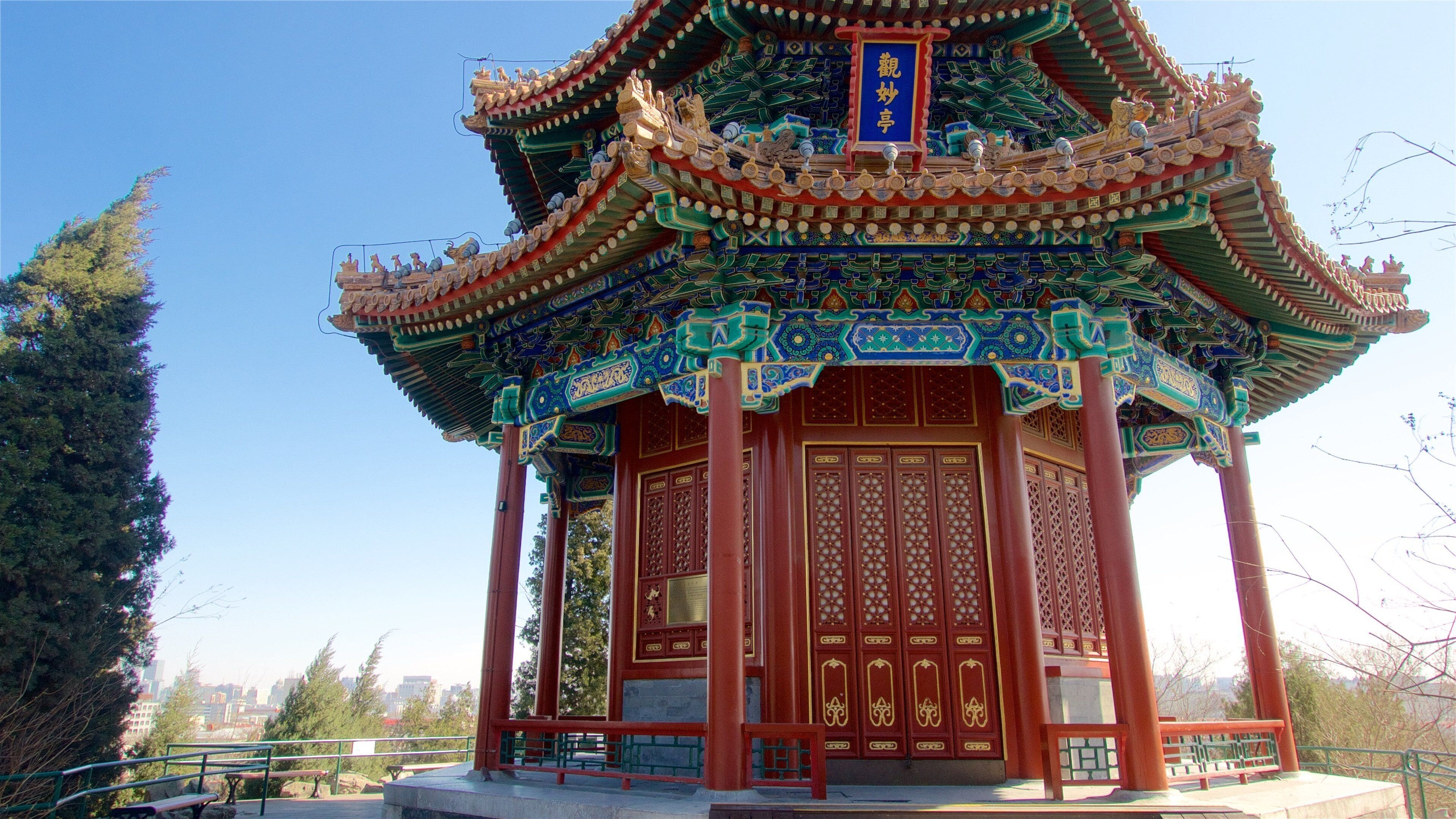 A traditional Chinese pavilion with ornate roof and intricate wooden carvings.