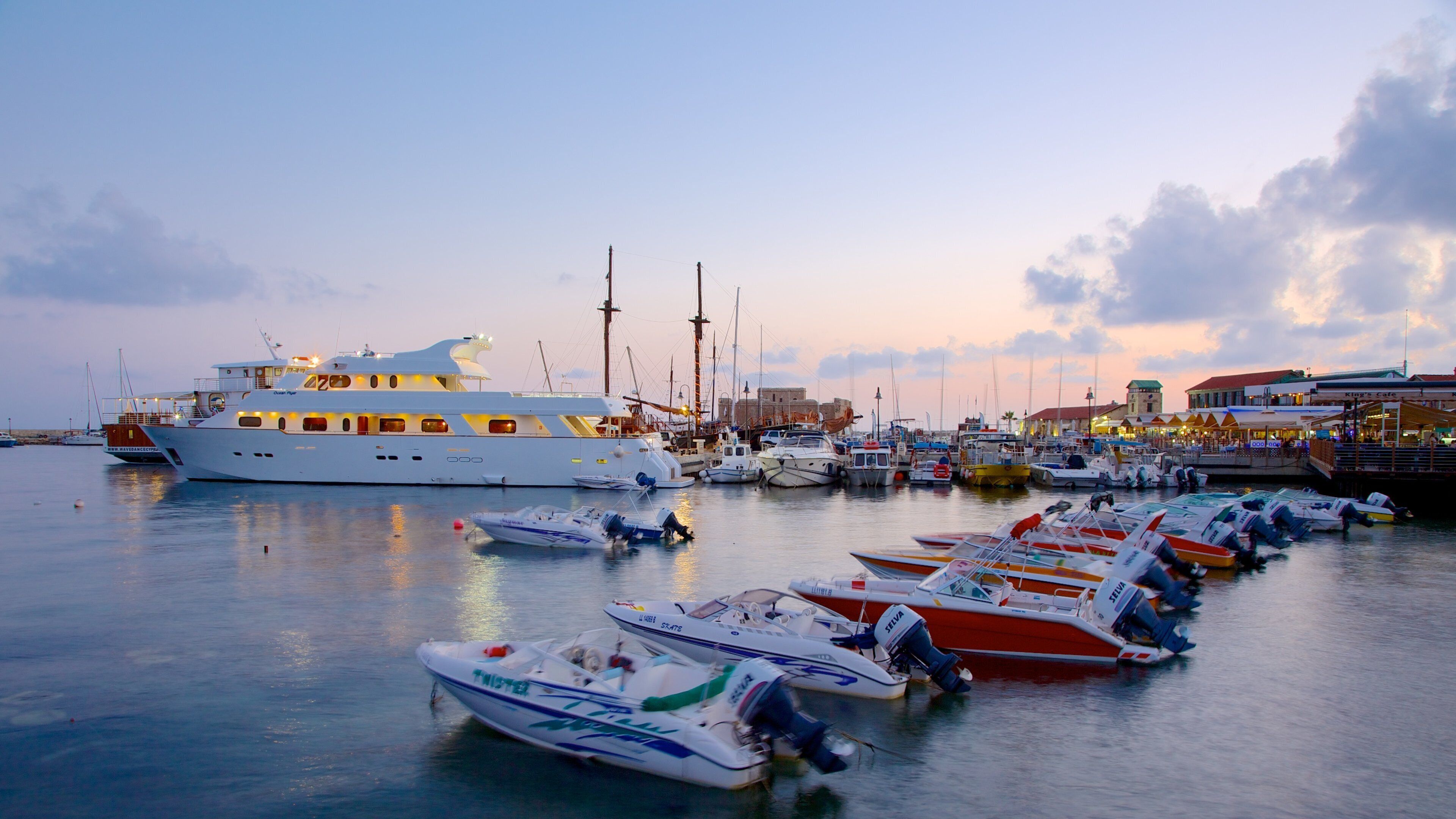 Paphos Harbour featuring a bay or harbor and a sunset