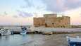 Paphos Harbour which includes a bay or harbour and a sunset