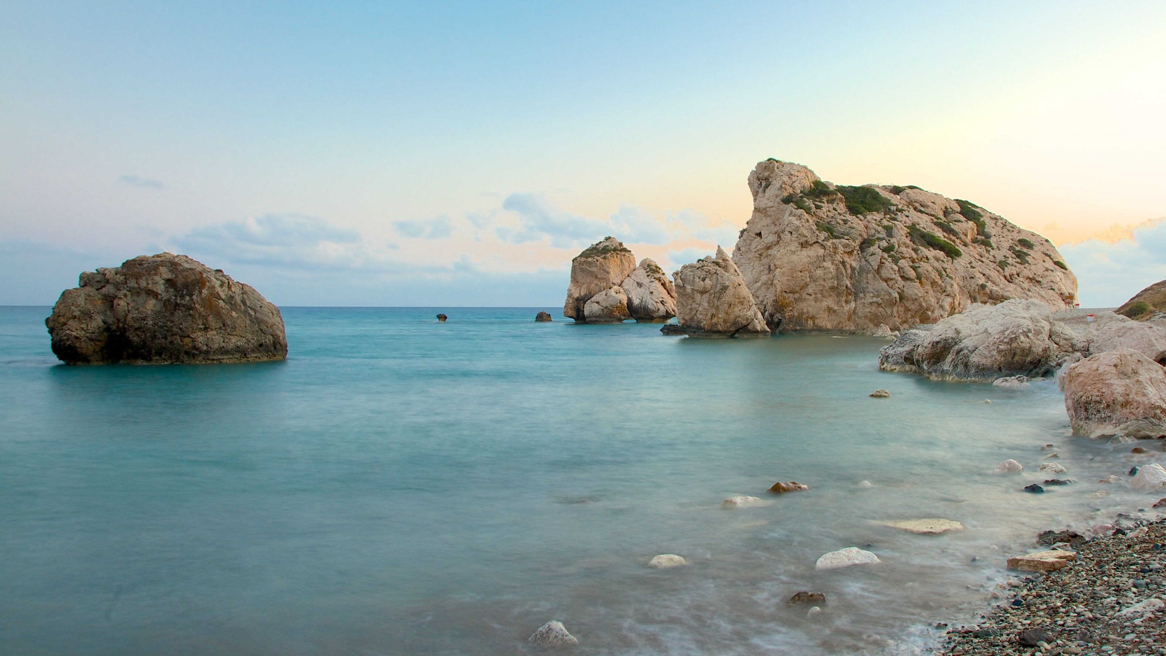 Aphrodite\'s Rock featuring rugged coastline and a sunset