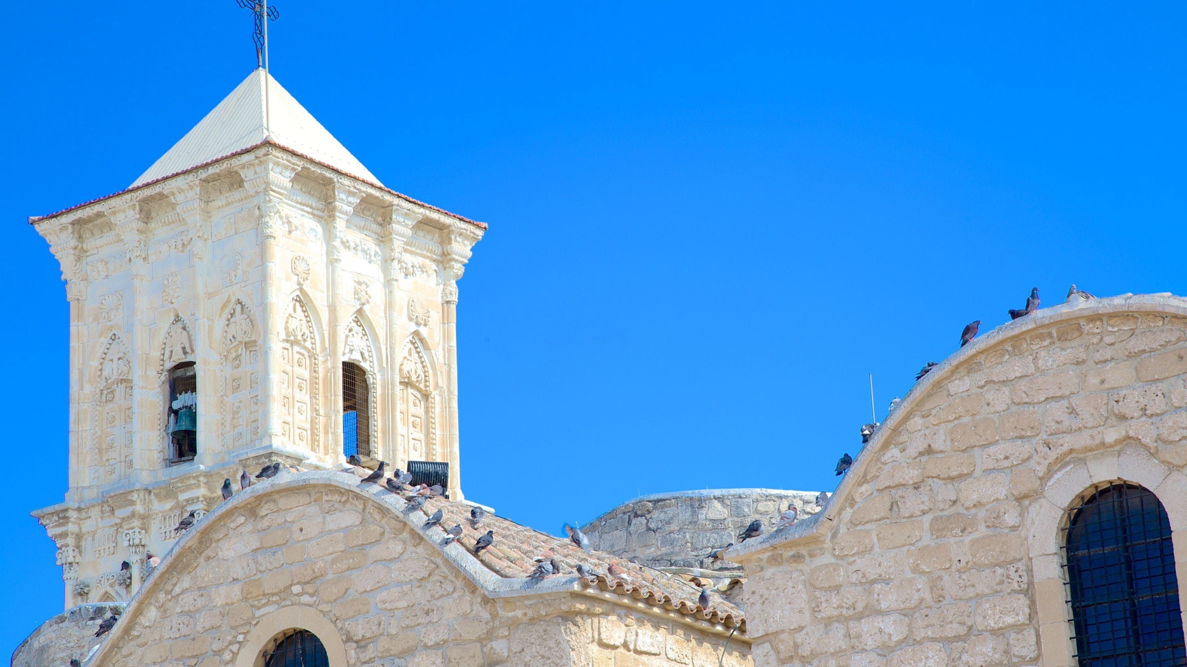 A historic church with intricate stone carvings and a bell tower.