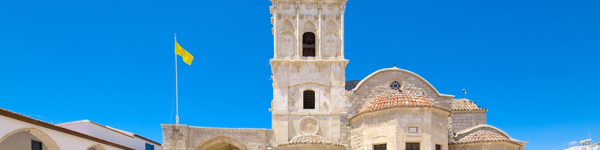 A historic church with a bell tower, arches, and a tiled roof.