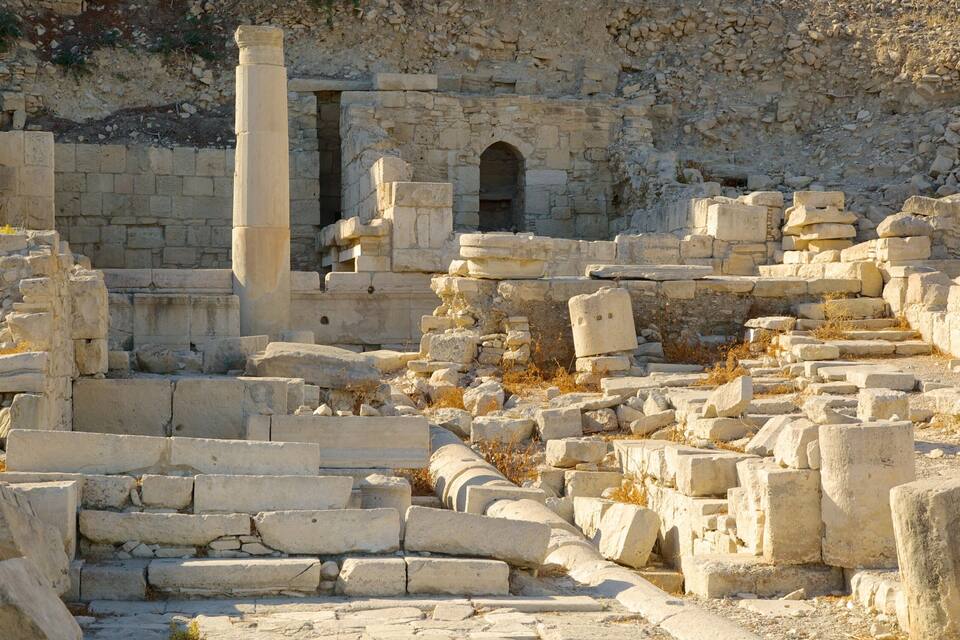 Ancient stone ruins with columns and arches.