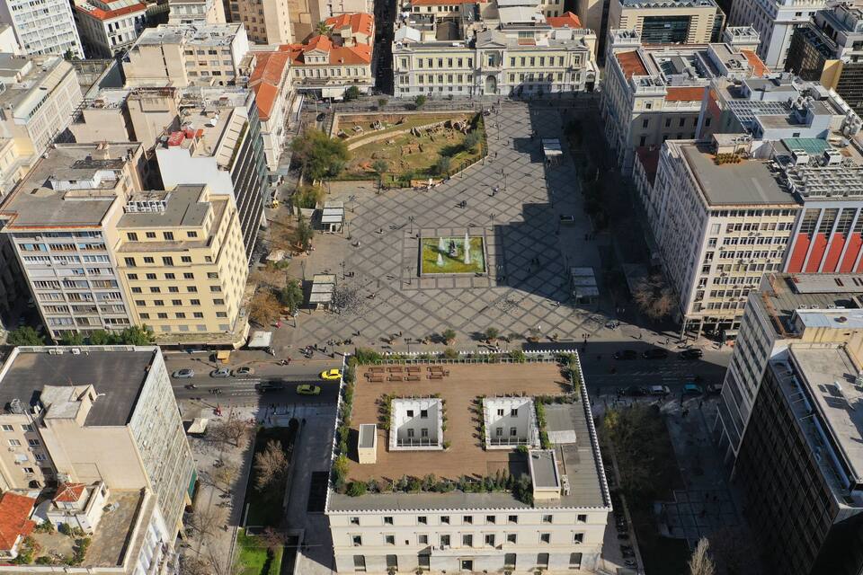 An aerial view of a city square surrounded by historic buildings.
