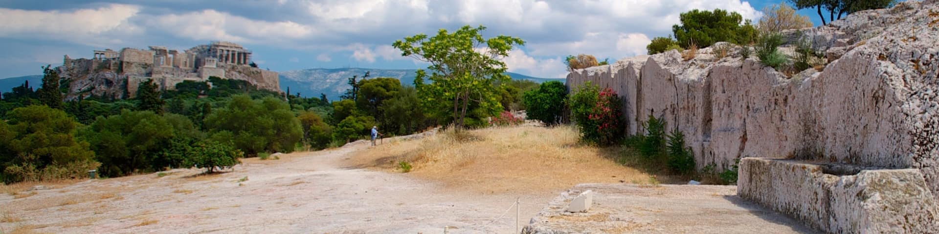 A rocky landscape with ancient ruins and a clear blue sky.