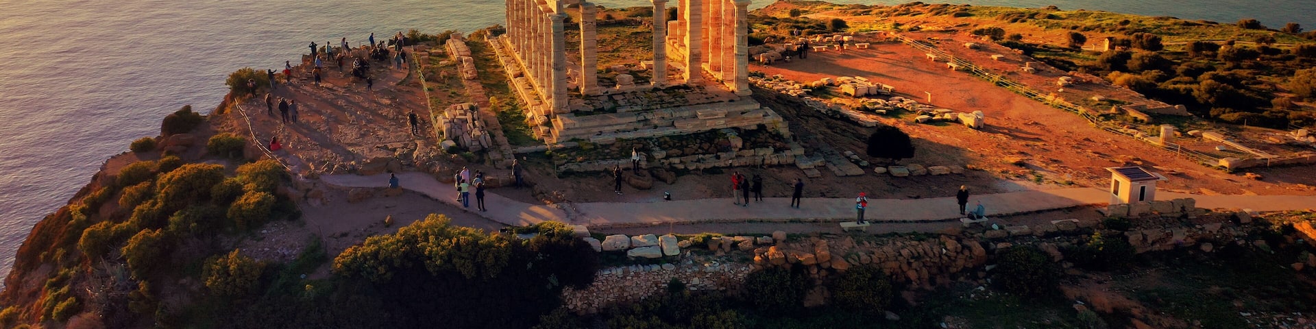 Aerial drone photo of sunset over the iconic Temple of Poseidon at Cape Sounio with amazing golden colours, Attica, Greece