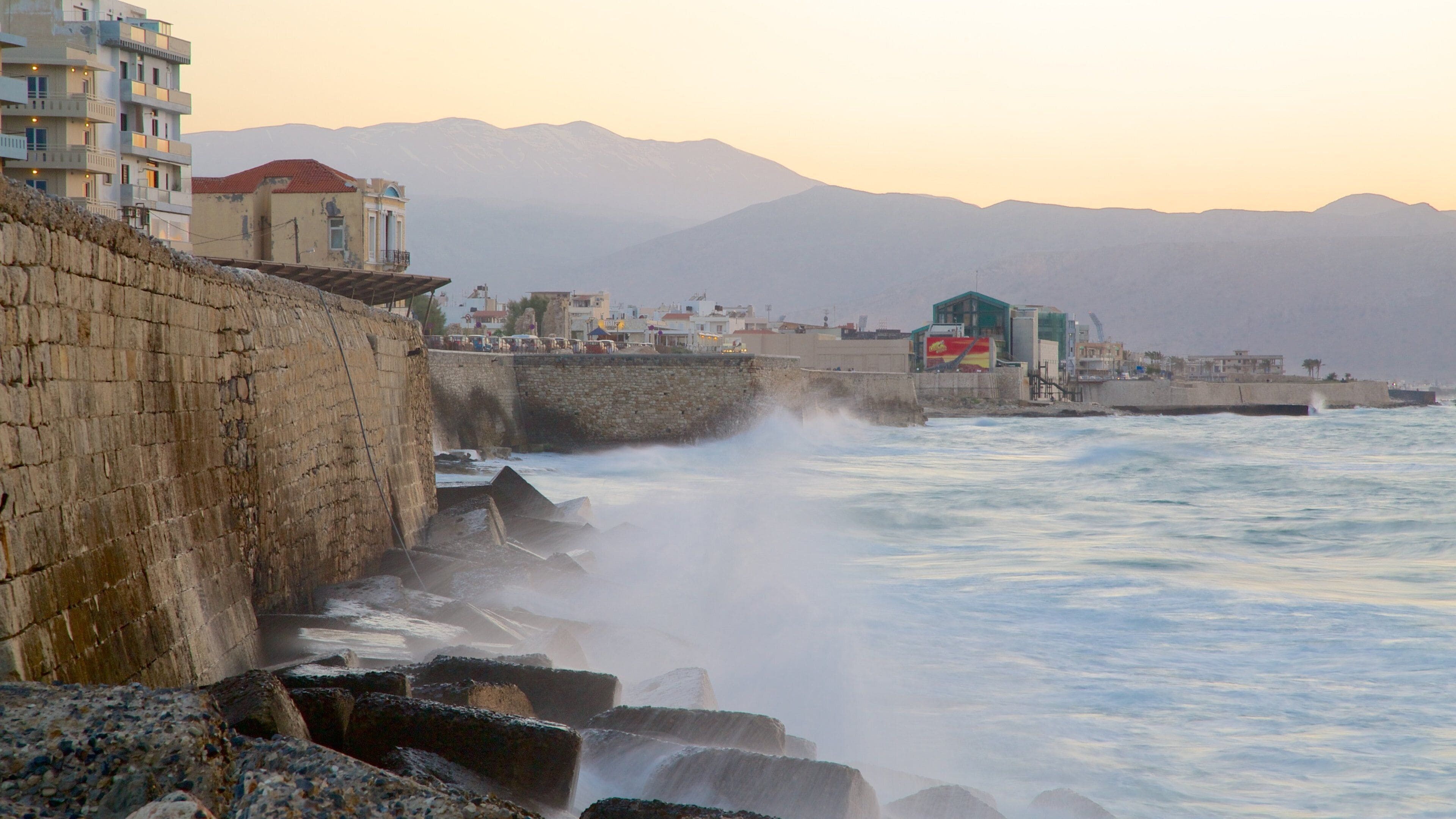 Heraklion Port featuring rocky coastline, a sunset and a marina