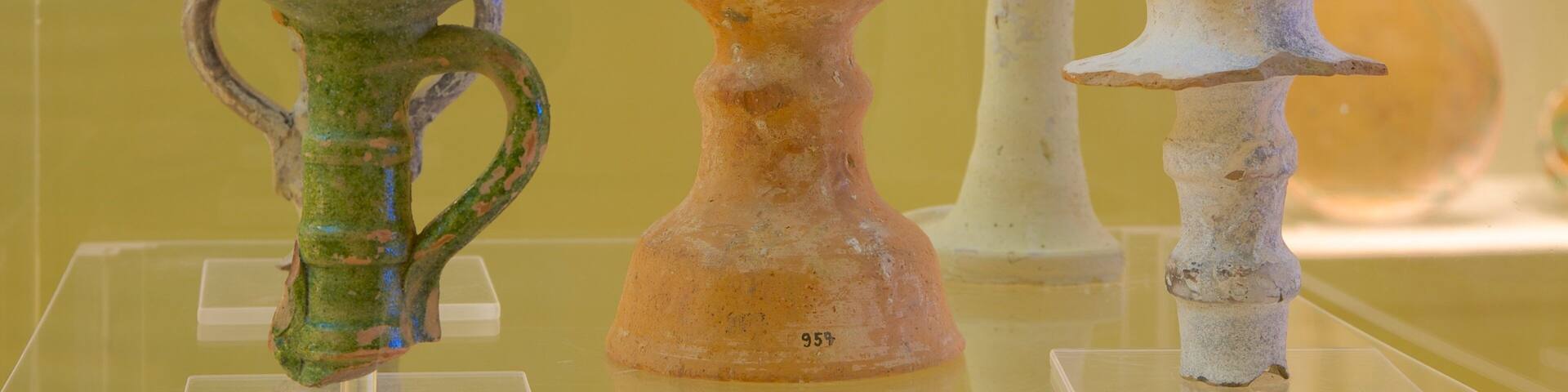 A collection of ancient pottery artifacts displayed in a museum.