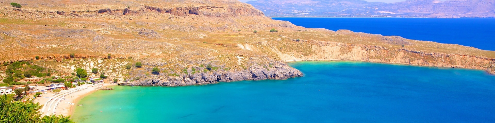 Lindos Beach which includes general coastal views and a bay or harbor