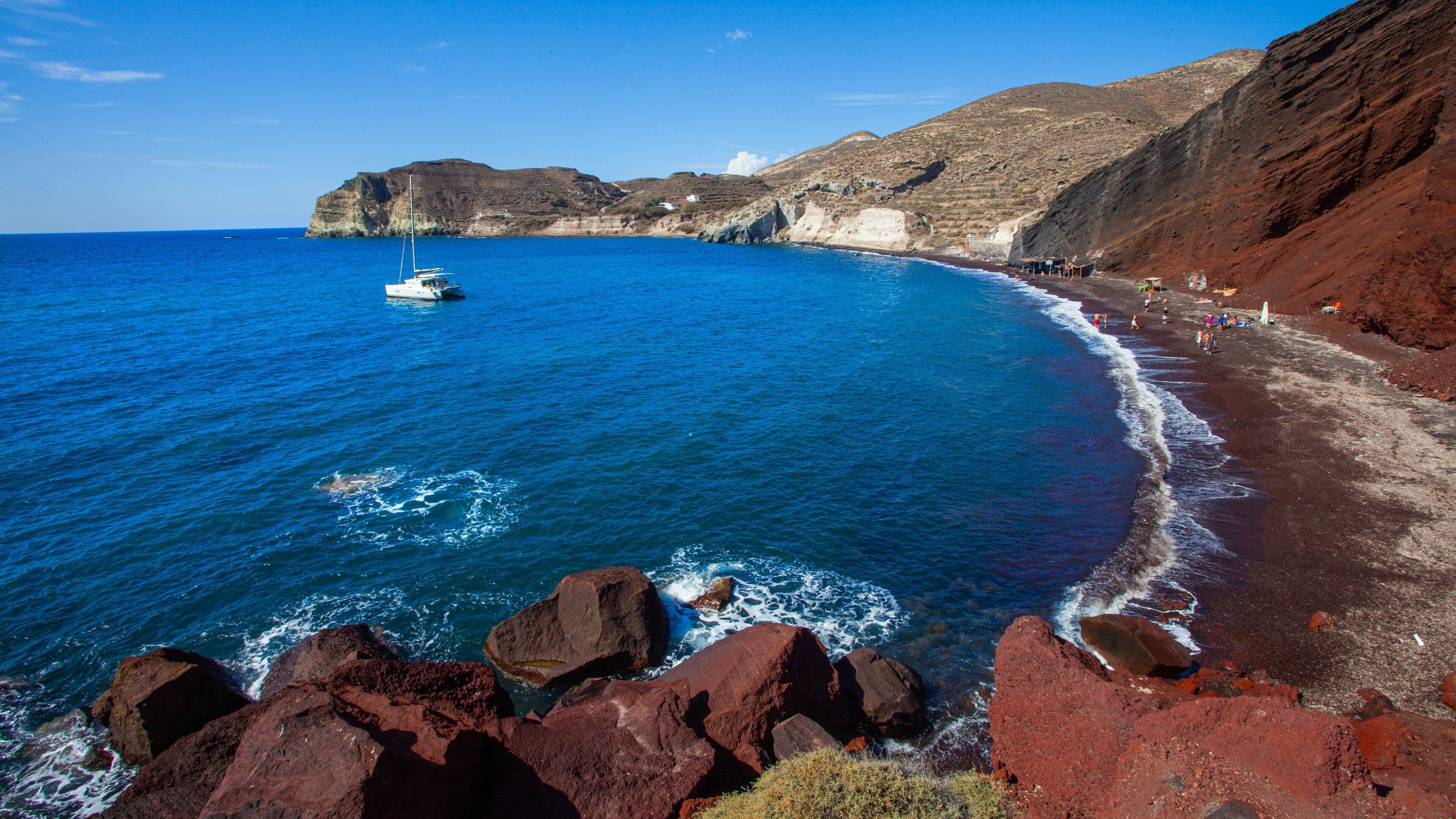 Red Beach which includes rugged coastline and general coastal views