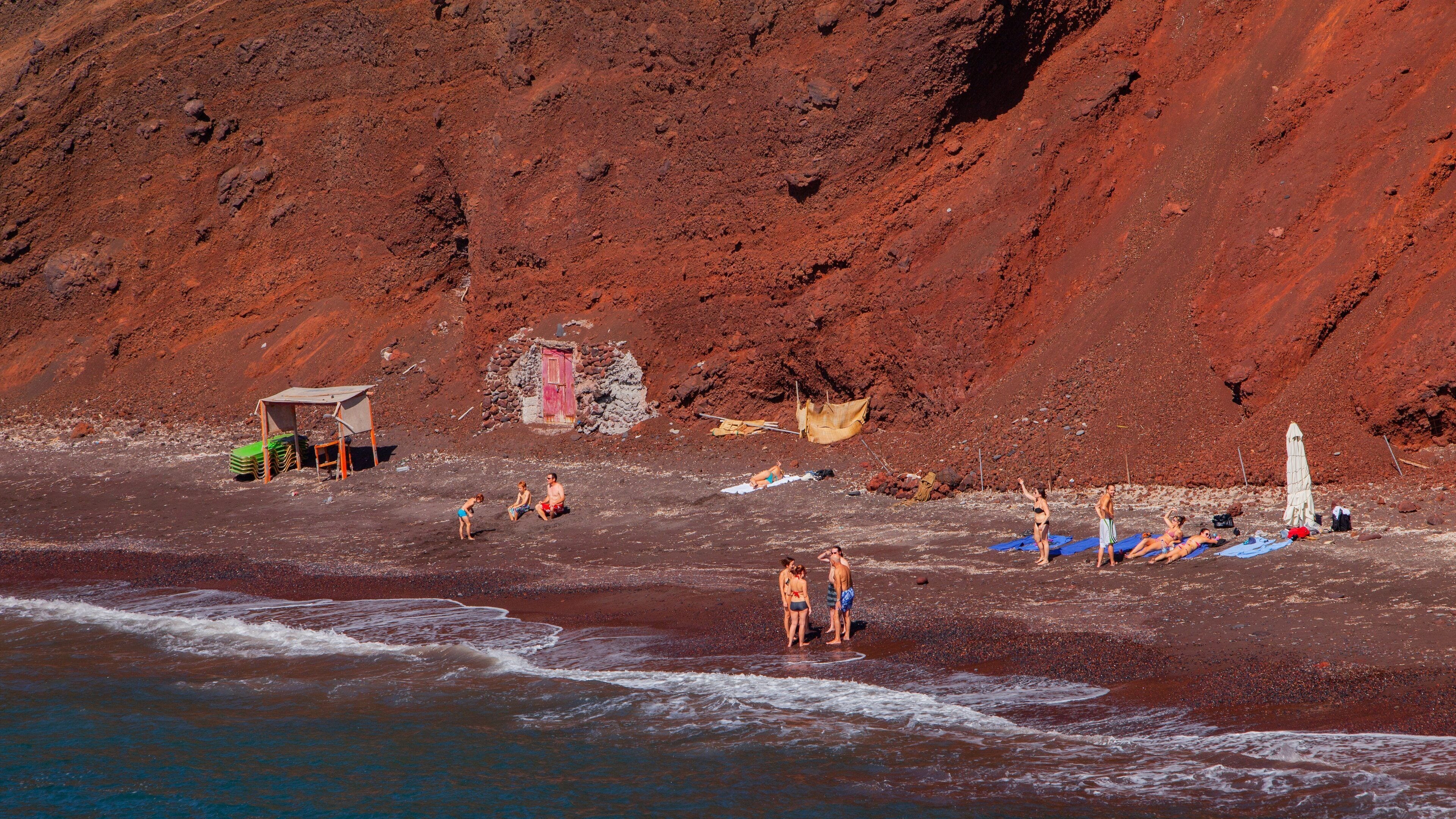 Santorini showing general coastal views and rocky coastline as well as a small group of people