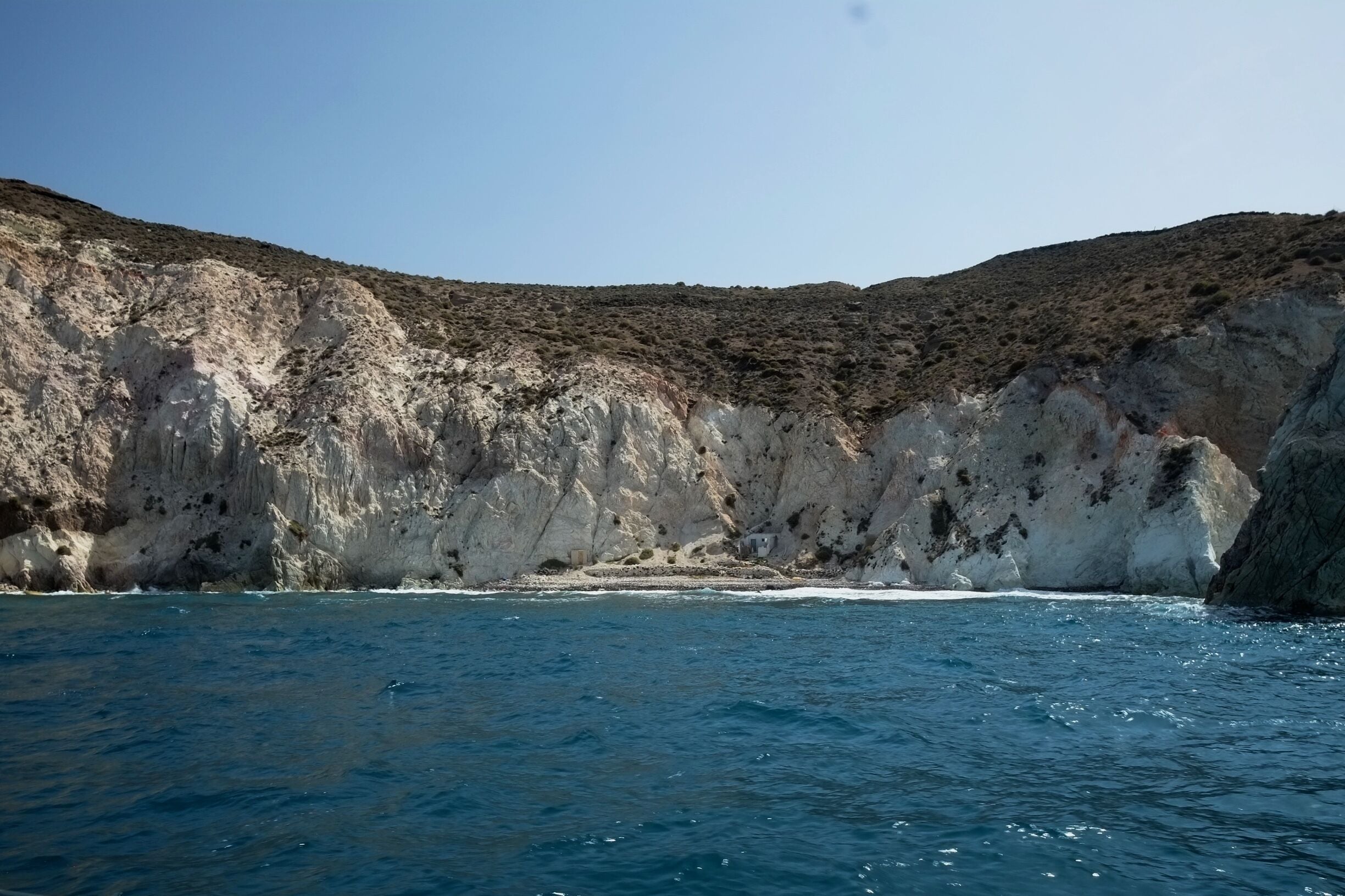 White Beach Santorini: The cove right next to the Red beach, on the southern side of Santorini, is known as the White beach. It is very similar to the Red beach, with black pebbles on the shore, only that the surrounding cliffs are white. This beach is accessible by boat or on foot from the Red beach.