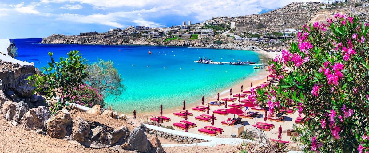 Panorama of Super Paradise Beach with Luxury Beach Club Umbrellas and Turquoise Aegean Sea in Mykonos Island Cyclades Greece
